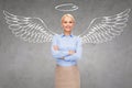 Happy businesswoman with angel wings and nimbus Royalty Free Stock Photo