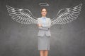Happy businesswoman with angel wings and nimbus Royalty Free Stock Photo