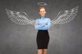 Happy businesswoman with angel wings and nimbus Royalty Free Stock Photo