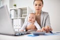 Happy businesswoman with baby and laptop at office