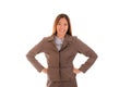 Happy businesswoman in brown suit is smiling and arms akimbo on Royalty Free Stock Photo