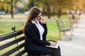 Happy businesswoman calling on mobile phone and taking notes outdoor Royalty Free Stock Photo