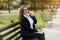 Happy businesswoman calling on mobile phone and taking notes outdoor Royalty Free Stock Photo