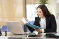 Happy businesswoman checking informs at office