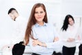 Happy businesswoman with colleagues in the background