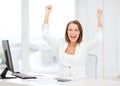 Happy businesswoman with computer in office