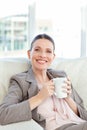 Happy businesswoman drinking a cup of coffee