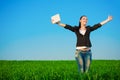 Happy businesswoman in a green field with a laptop Royalty Free Stock Photo