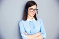 Happy businesswoman with headset and arms folded Royalty Free Stock Photo