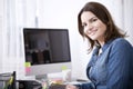 Happy Businesswoman at her Desk Looking at Camera Royalty Free Stock Photo