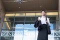 Businesswoman holding coffee outside office building. beautiful Royalty Free Stock Photo