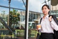 Businesswoman holding coffee outside office building. beautiful Royalty Free Stock Photo