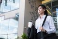 Businesswoman holding coffee outside office building. beautiful Royalty Free Stock Photo