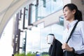 Businesswoman holding coffee outside office building. beautiful Royalty Free Stock Photo