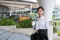 Businesswoman holding coffee outside office building. beautiful Royalty Free Stock Photo