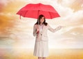 Happy businesswoman holding umbrella