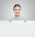 Happy businesswoman holding white empty signboard paper card background. Young woman smiling, business and education concept Royalty Free Stock Photo