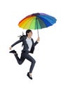 Happy businesswoman jumping with umbrella Royalty Free Stock Photo