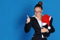 Happy businesswoman with laptop, Christmas hat