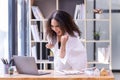 Happy businesswoman laughing with joy at the good news about work at the workplace, gladly looking at laptop screen, feeling