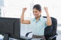 Happy businesswoman looking at computer in office Royalty Free Stock Photo