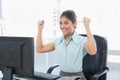 Happy businesswoman looking at computer in office Royalty Free Stock Photo