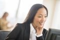 Happy Businesswoman Looking At Computer In Office Royalty Free Stock Photo