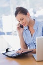 Happy businesswoman looking at her diary and calling Royalty Free Stock Photo