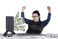 Happy businesswoman looking money on screen Royalty Free Stock Photo