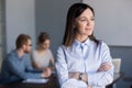 Smiling businesswoman looking from window dreaming of future suc