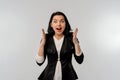 Happy businesswoman looking surprise with open mouth, raising hands up with enthusiastic face expression, is happy about a big Royalty Free Stock Photo
