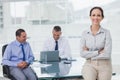 Happy businesswoman posing leaning against the desk Royalty Free Stock Photo