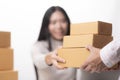 Happy businesswoman receiving a package sitting on a desk at off Royalty Free Stock Photo