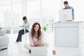 Happy businesswoman sitting on the floor using laptop Royalty Free Stock Photo