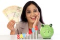 Happy businesswoman with stack of coins and holding rupee notes Royalty Free Stock Photo