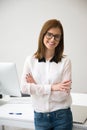 Happy businesswoman standing with arms folded Royalty Free Stock Photo