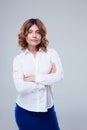 Happy businesswoman standing with arms folded Royalty Free Stock Photo