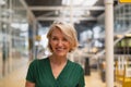 Happy Businesswoman standing in the corridor at office Royalty Free Stock Photo