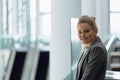 Happy Businesswoman standing in the corridor at office Royalty Free Stock Photo