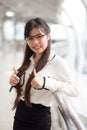 Happy businesswoman standing on sidewalk. Royalty Free Stock Photo