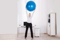 Businesswoman Stretching Her Arms In Office