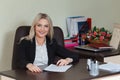 Happy businesswoman in suit smiling and looking at camera. Royalty Free Stock Photo