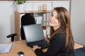 happy businesswoman using computer while sitting at the desk at office Royalty Free Stock Photo