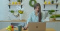 Happy businesswoman using laptop computer at home office in slow motion. Cheerful woman working laptop at table on Royalty Free Stock Photo