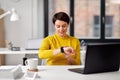 Happy businesswoman using smart watch at office Royalty Free Stock Photo