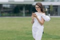 Happy businesswoman using smartphone wearing in blue shirt and glasses. Cheerful attractive young businesswoman in Royalty Free Stock Photo