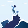 Happy businesswoman winner with cup standing on top of mountain peak,