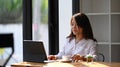 Businesswoman working on computer preparing presentation.