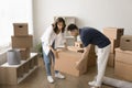 Happy busy couple of home owners unpacking cardboard boxes Royalty Free Stock Photo