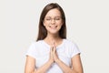 Happy calm grateful girl join hands praying isolated on background